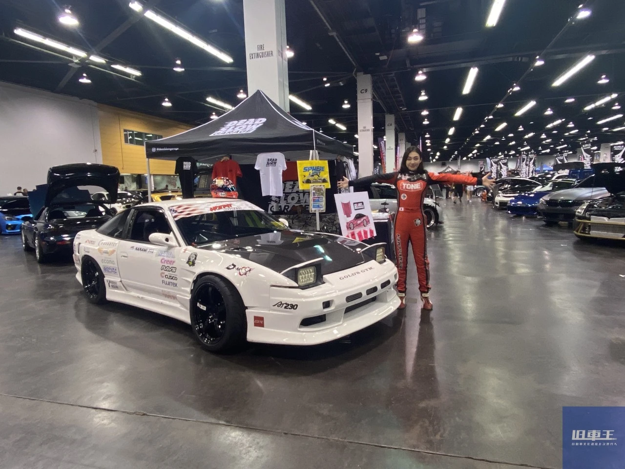 会場で車の隣で両手を広げる塚本ナナミ